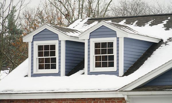 A house with snow on its roof.