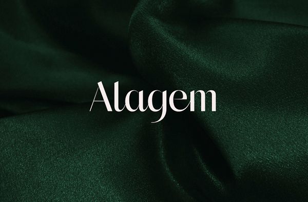 White Alagem logo place on top of an image of green fabric scrunched up.