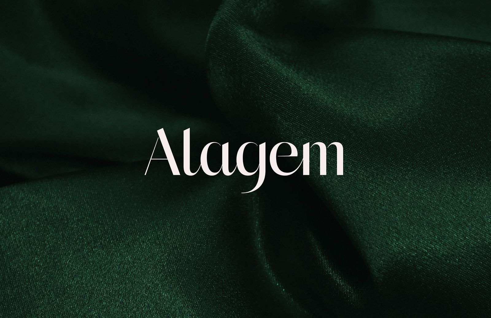 White Alagem logo place on top of an image of green fabric scrunched up.