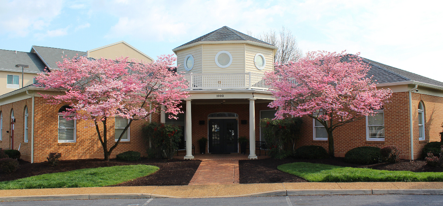 Picture of front of Harrisonburg office with pink blooms on trees