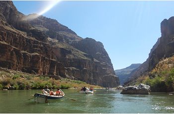 Two rafts float float on teh Colorado River