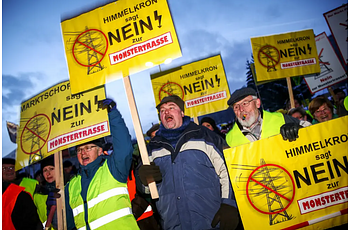 Protesters with signs against a high-voltage power line in Pegnitz, Germany
