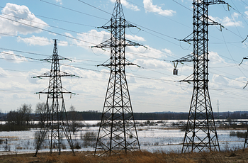 Three electrical power toers in front of flooded area