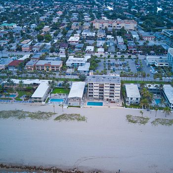 Aerial shot of buildings, with ocean flooding in foreground