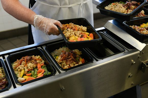 A photo of meals lined up as they are being prepared in the God's Love kitchen.