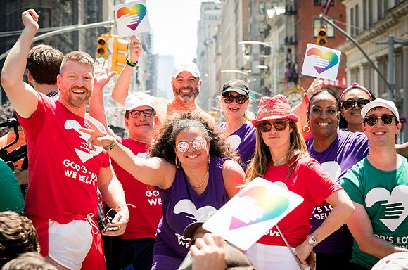 A group of God's Love supporters on the a Pride float celebrating.