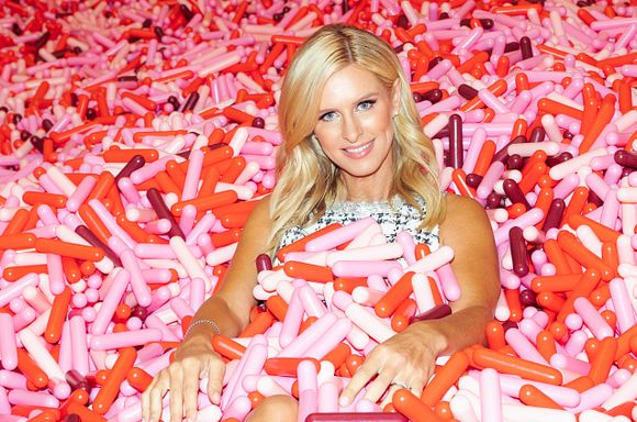 A photo of Nicky Hilton in the Museum of Ice Cream sprinkle pit.