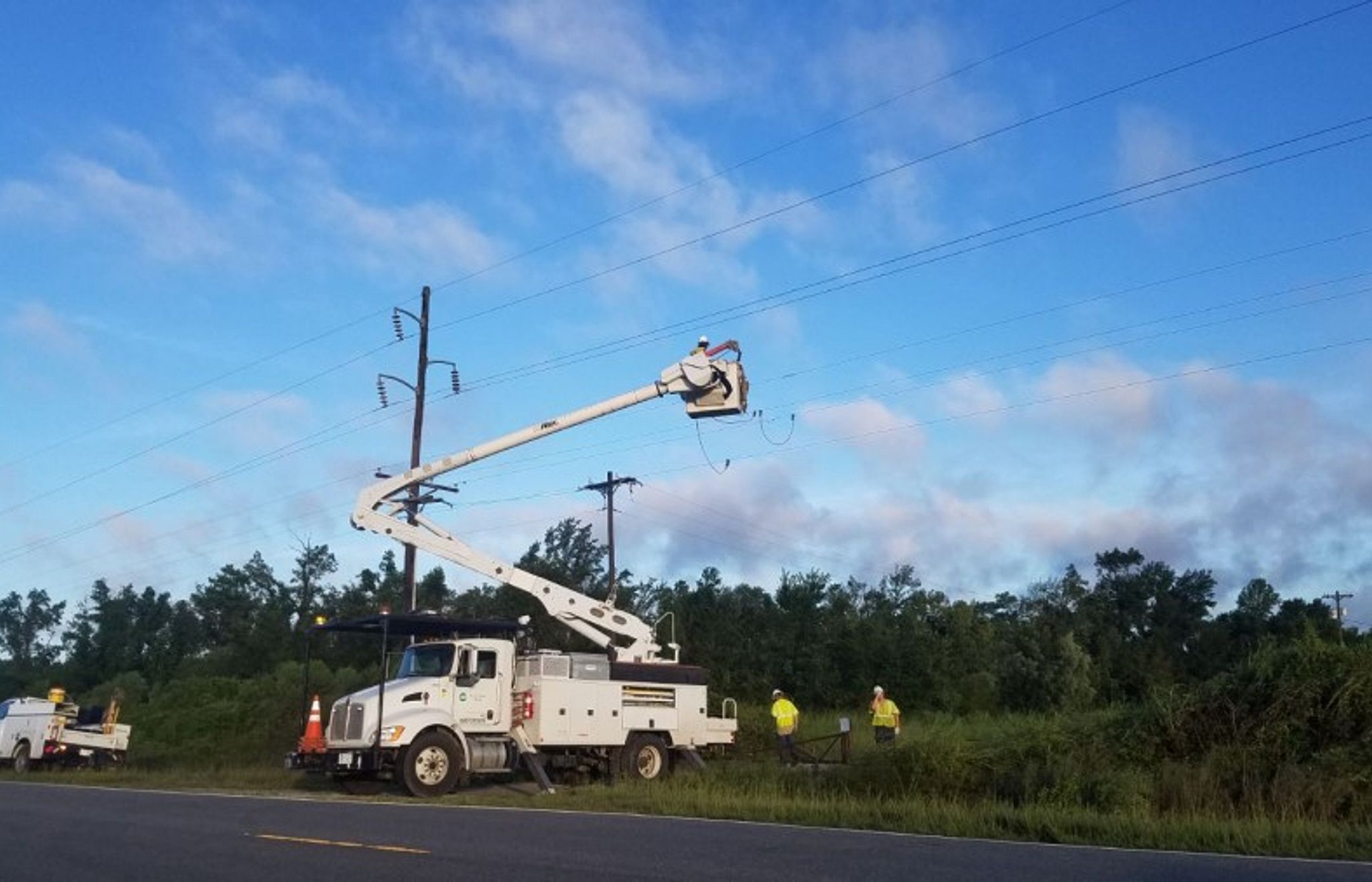 Utility truck and crews restoring power