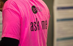 staff member wearing a t-shirt that says ask me.