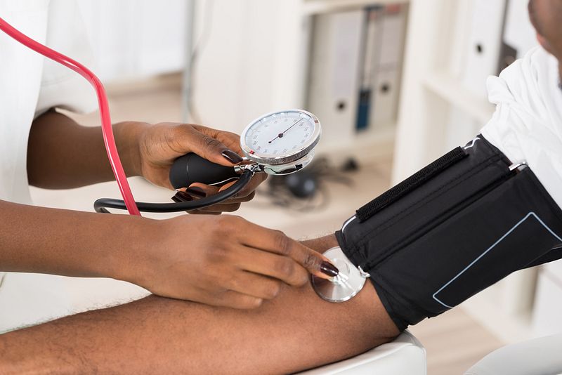 A medical professional takes a patient's blood pressure