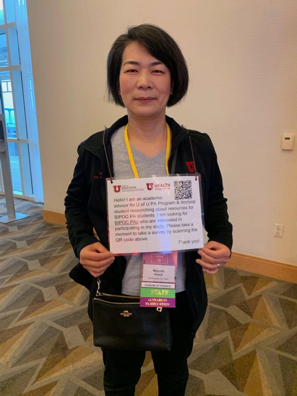 Mayumi Kasai wears a QR code to collect research responses