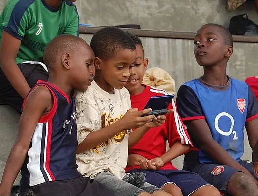 Children play the Breakaway video game on their device