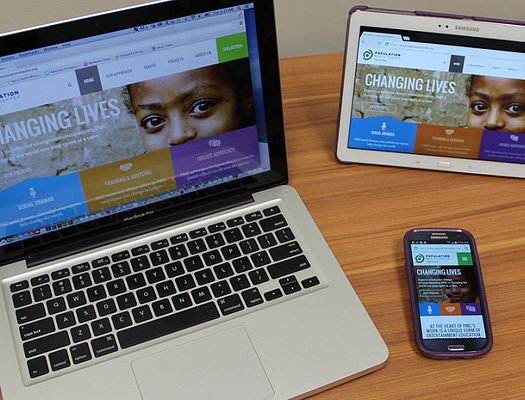 PMC's new website on a computer, tablet, and phone