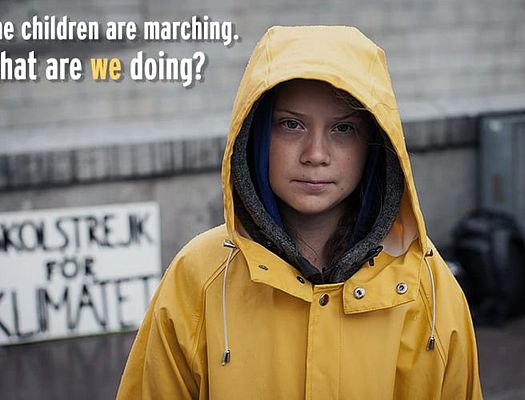 Photo of Greta Thunberg in a yellow rain jacket. The graphic text says "The children are marchin. What are we doing?"