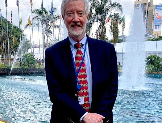Photo of Bill Summit in front of a fountain