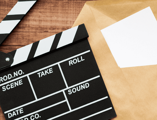 movie clapperboard with an envelope next to it