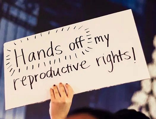 handwritten sign that says "hands off my reproductive rights"