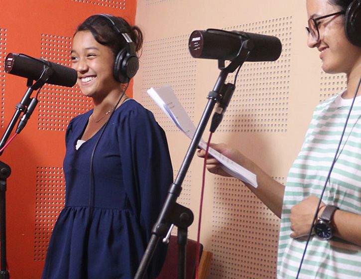young girls in a recording studio. smiling in between takes.