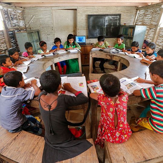 Boat school in Bagladesh, children in a class seated at a lesson.