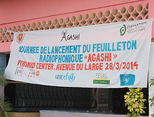 Project launch in Burundi with a white banner listing information about the Agashi show
