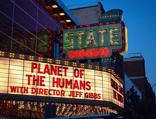 A movie marquee that says "Planet of The Humans"