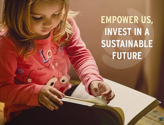 A girl flips through a book. There is a graphic to the right of her that says "Empower us, Invest in a Sustainable Future"