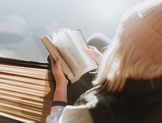 stock photo of a woman flipping through a book