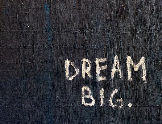 Black wall with 'Dream Big' written on it in white
