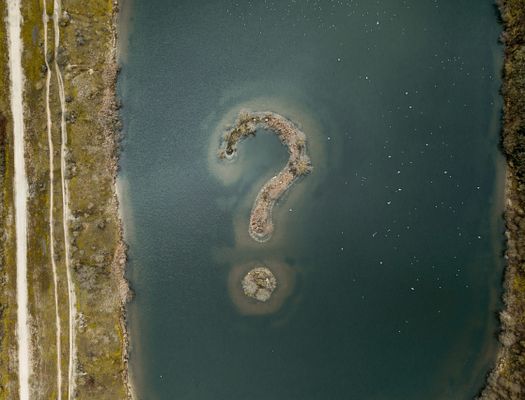 Islands shaped like question mark in lake