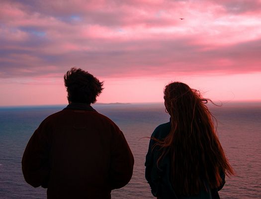 A couple looking out to sea. Photo by Matteo Raw on Unsplash